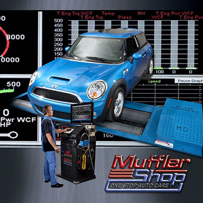 A man in front in front of a computer and blue car